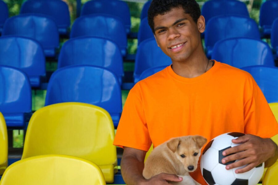 footballer with dog in grandstand